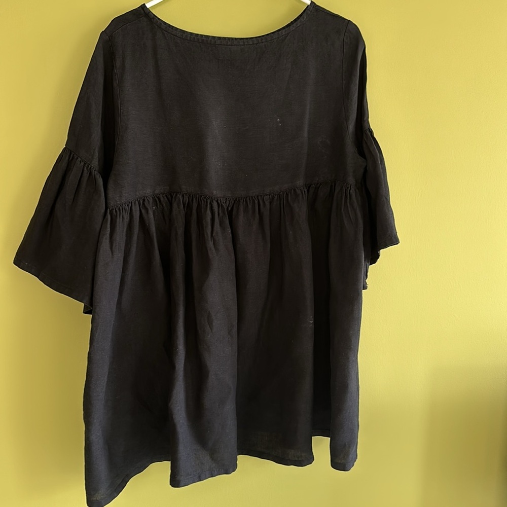 Bryn Walker black linen tunic top with gathered back detail and ruffle sleeves.